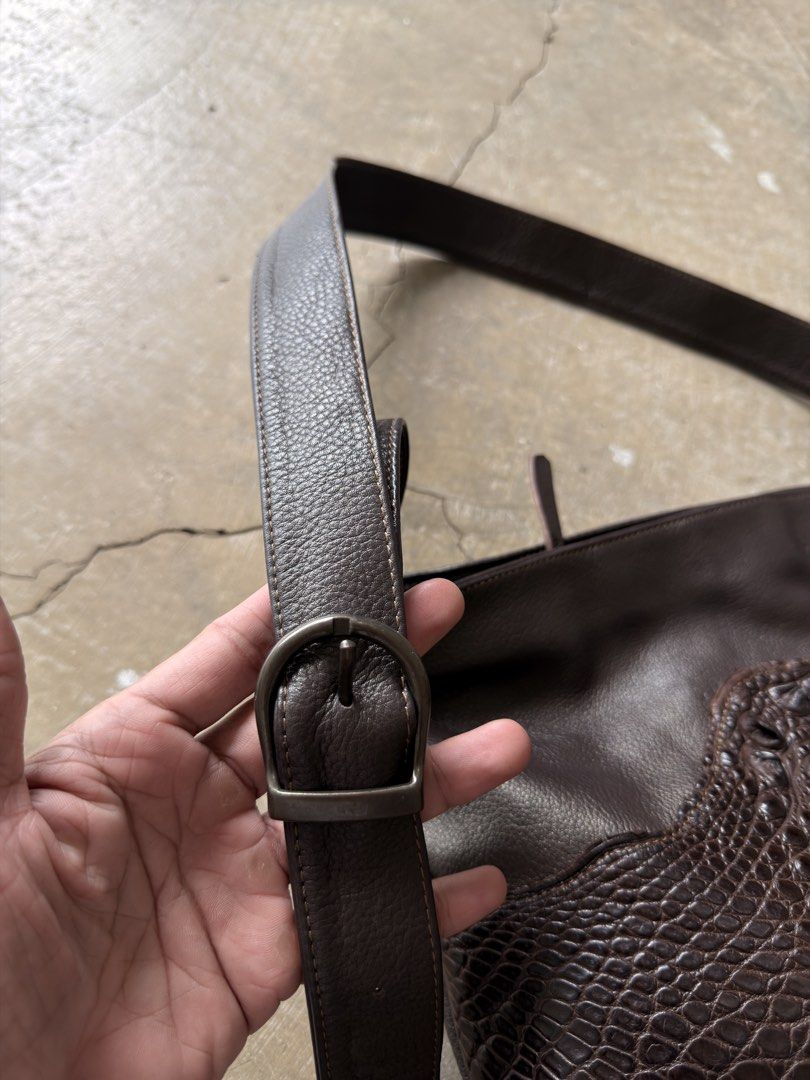 Custom Leather Shoulder Bag with Crocodile Embossing (Category: Shoulder Bags) located in Alfonso. Submitted by jbcamet (Listing ID 1461282423, Image 3). Description: - Dark brown leather shoulder bag - Unique patchwork design - Crocodile-embossed leather accents - Adjustable strap with buckle - Zippered pocket on the back - Spacious interior - Ideal for everyday use.
