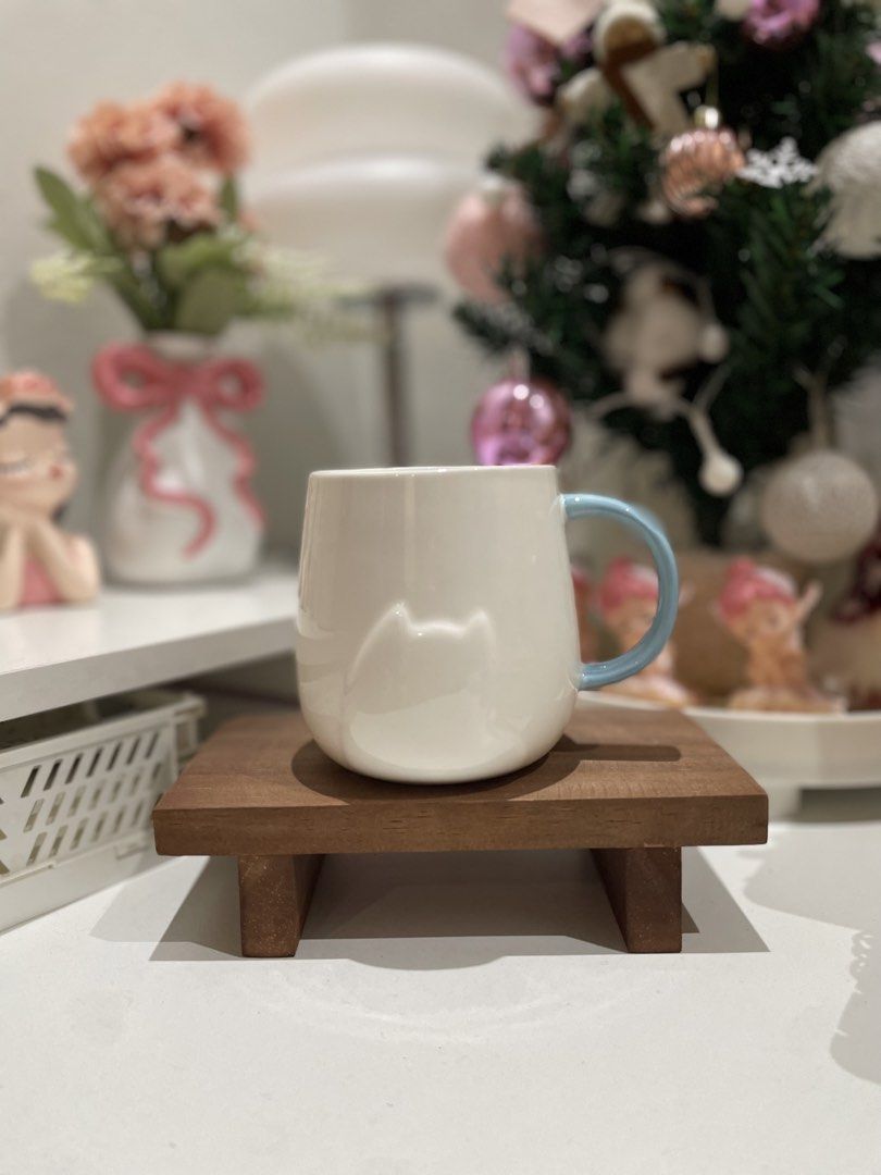 Cute Cat Mug with Blue Handle (Category: Coffee & Tea Tableware) located in Quezon City. Submitted by mugs.meowph (Listing ID 1461278403, Image 1). Description: - White ceramic mug - Adorable cat outline design - Light blue handle - Perfect for coffee or tea - Great gift for cat lovers - Adds a fun touch to your kitchen.