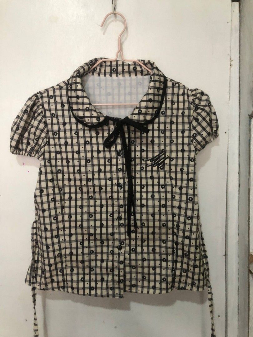 Cute Plaid Blouse with Bow Detail (Category: Blouses) located in Mandaluyong City. Submitted by chloesy69 (Listing ID 1461119783, Image 1). Description: - Cream and black plaid blouse - Short puff sleeves - Cute tie-bow at the collar - Small floral print scattered throughout - Tie details at the back - Perfect for casual or dressy outfits note: payment first mop: gcash or gotyme.