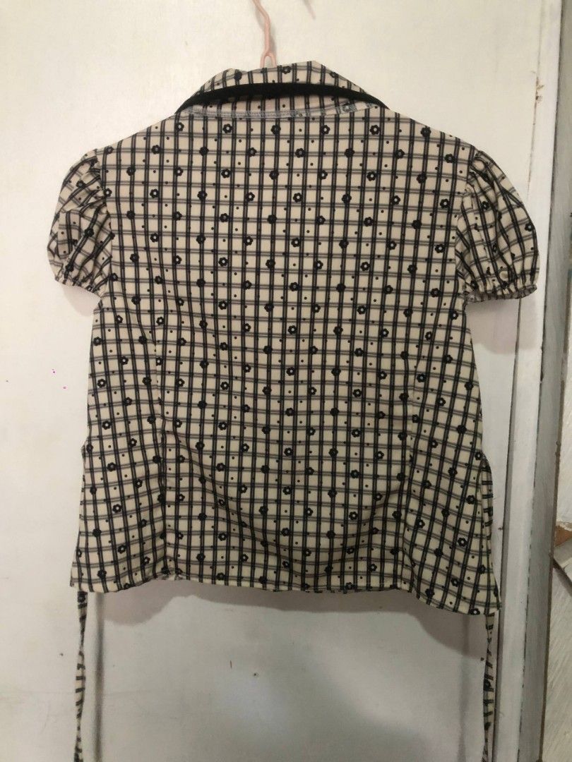 Cute Plaid Blouse with Bow Detail (Category: Blouses) located in Mandaluyong City. Submitted by chloesy69 (Listing ID 1461119783, Image 2). Description: - Cream and black plaid blouse - Short puff sleeves - Cute tie-bow at the collar - Small floral print scattered throughout - Tie details at the back - Perfect for casual or dressy outfits note: payment first mop: gcash or gotyme.