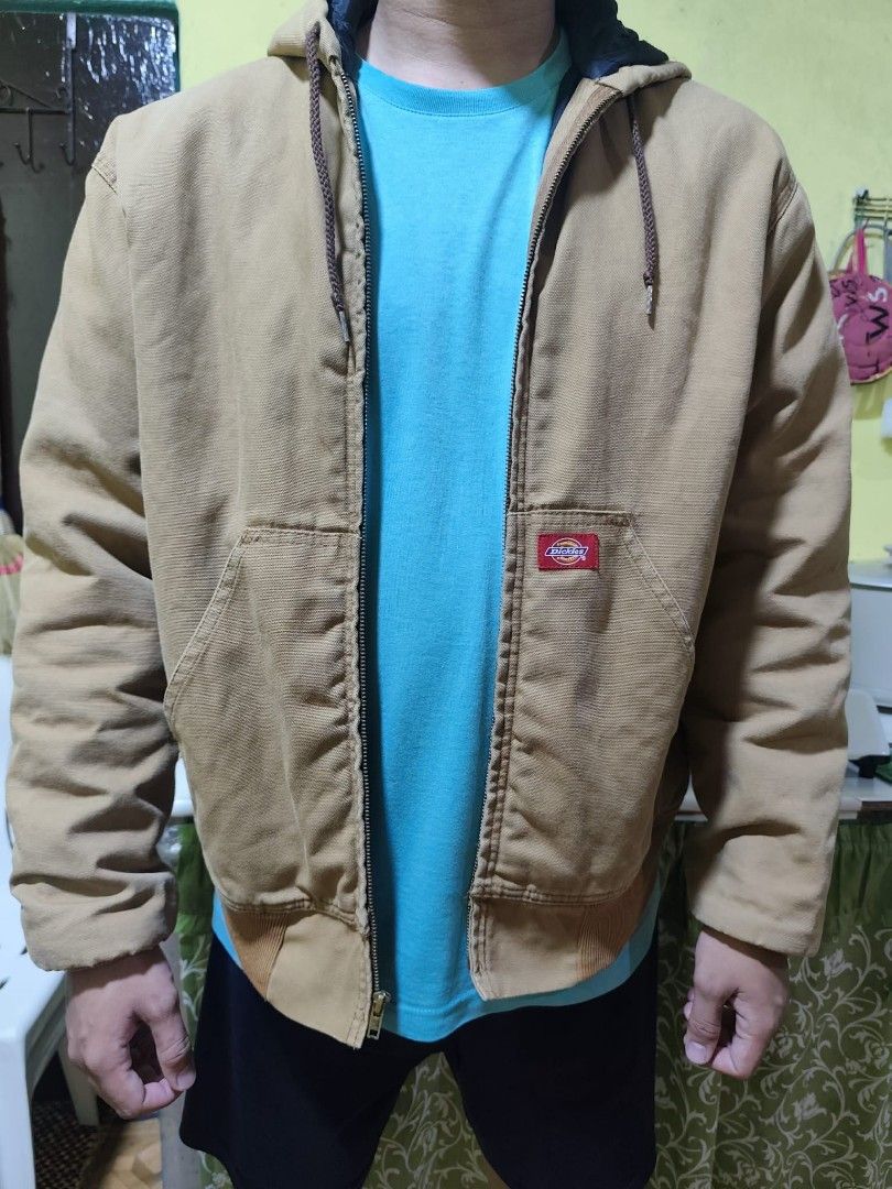 Dickies Insulated Hooded Work Jacket Tan (Category: Coats, Jackets and Outerwear) located in General Trias. Submitted by neloo1. (Listing ID 1461223699, Image 2). Description: vintage dickies active duck jacket - Classic tan Dickies work jacket - Insulated for warmth - Features a hood and front pocket - Durable canvas material - Ribbed cuffs and hem for a snug fit - Zipper closure - Ideal for work or casual wear.