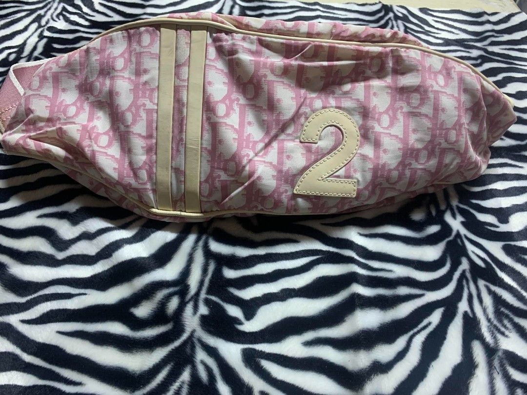 Dior Monogram Pink Canvas Waist Bag (Category: Luxury Bags & Wallets) located in Gapan. Submitted by cleverstar.36492b (Listing ID 1461140363, Image 2). Description: Authentic Dior saddle bag style waist bag. Pink monogram canvas with cream leather trim. Features the iconic Diorissimo pattern. Has a front number '2' detail. Adjustable strap with Dior branded buckle. Zipped compartments for storage. Great for everyday use or travel..