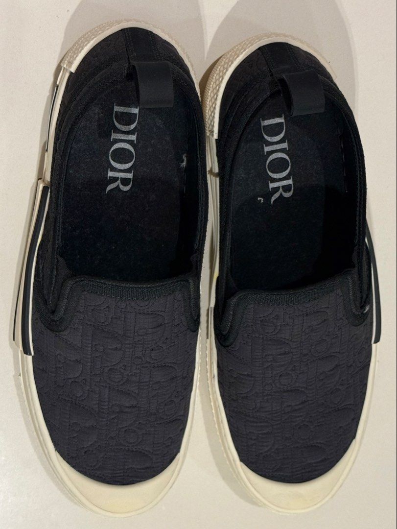 DiOR Slip-On Sneakers ❗️❗️❗️ (Category: Sneakers & Footwear) located in Manila. Submitted by hotdealsph (Listing ID 1461265976, Image 1). Description: - Authentic Dior slip-on sneakers - Features the iconic Dior all-over logo pattern - Comfortable white rubber sole - Easy slip-on design for convenience - Ideal for casual everyday wear.