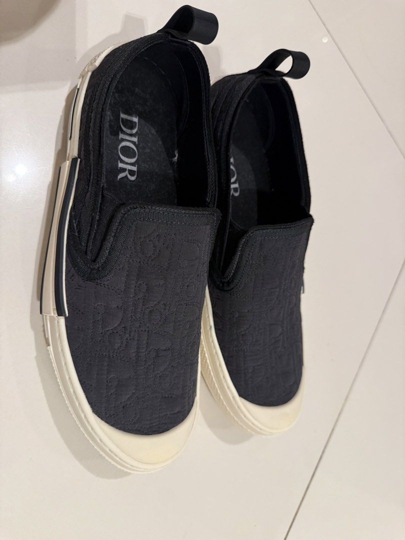 DiOR Slip-On Sneakers ❗️❗️❗️ (Category: Sneakers & Footwear) located in Manila. Submitted by hotdealsph (Listing ID 1461265976, Image 2). Description: - Authentic Dior slip-on sneakers - Features the iconic Dior all-over logo pattern - Comfortable white rubber sole - Easy slip-on design for convenience - Ideal for casual everyday wear.