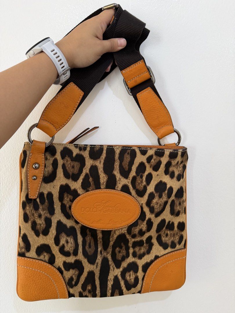 Dolce & Gabbana Leopard Print Crossbody Bag (Category: Cross-body Bags) located in Manila. Submitted by escarchame98247 (Listing ID 1461162012, Image 1). Description: - Authentic Dolce & Gabbana crossbody bag - Fun leopard print with tan leather accents - Adjustable strap for comfortable wear - Versatile for everyday use or nights out.