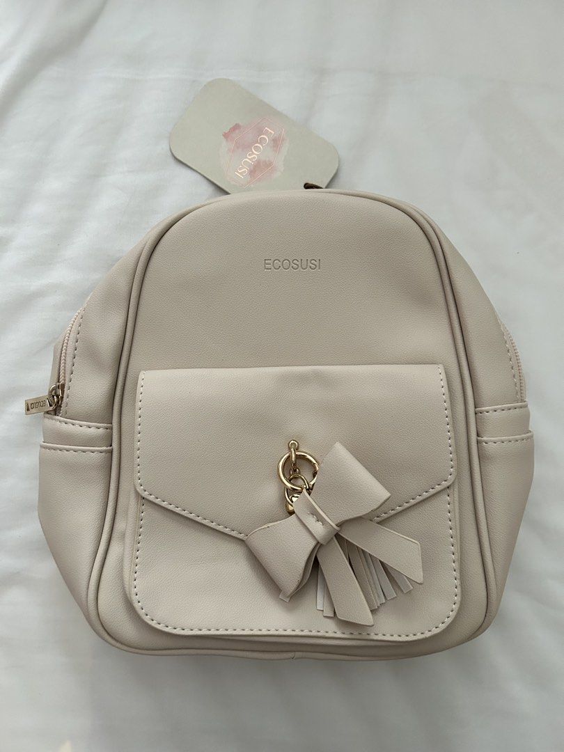 ECOSUSI Cream Bow Detail Mini Backpack (Category: Backpacks) located in Paranaque City. Submitted by nicolelagleva (Listing ID 1461127921, Image 1). Description: - Cute cream mini backpack from ECOSUSI - Features a sweet bow and tassel detail on the front pocket - Adjustable straps for comfortable wear - Includes a main compartment and a zippered inner pocket - Ideal for everyday use or a night out - Comes with original tag.
