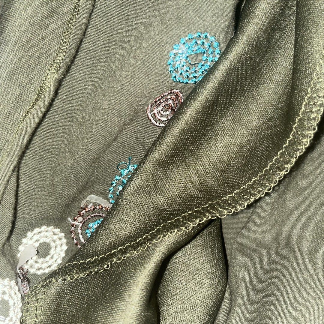 Embroidered Tank Top (Category: Sleeveless) located in Makati City. Submitted by midnightmelhem (Listing ID 1461133253, Image 3). Description: - Olive green tank top - Embroidered circular and floral patterns (white, brown, teal) - Spaghetti straps - Fabric has a slight sheen - Ideal for casual wear or layering.