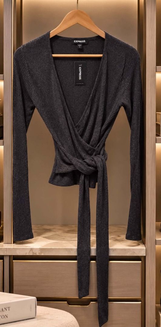 Express Ribbed Knit Wrap Top (Category: Blouses) located in Cebu City. Submitted by classy82 (Listing ID 1461124863, Image 1). Description: - Brand: Express - Color: Dark Grey - Material: Ribbed Knit - Style: Wrap Top - Features: Long sleeves, tie waist, subtle shimmer - Versatility: Perfect for dressing up or down, layering, or wearing alone..