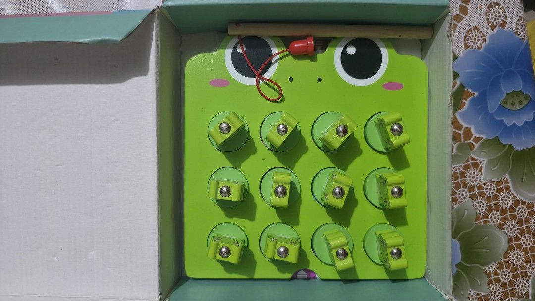 Fishing Frog Memory Game 36+ Months (Category: Educational & Learning Toys) located in Quezon City. Submitted by fabfindsph (Listing ID 1461223250, Image 1). Description: - Fun fishing frog memory game for kids 36 months and up. -Wood material - Comes with 12 pieces. - Helps develop memory and fine motor skills. - Great for little ones to play and learn. - Features a cute frog design with colorful circles and little frogs to catch..