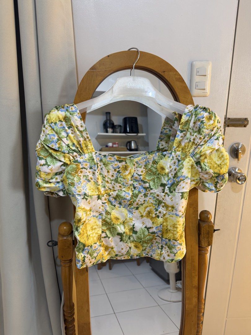 Floral Puff Sleeve Square Neck Top (Category: Blouses) located in Mandaluyong City. Submitted by chocofudge__ (Listing ID 1461152179, Image 2). Description: - Cute yellow floral print - Puff sleeves - Square neckline - Cropped fit - Versatile for pairing with high-waisted bottoms - Ideal for casual outings or brunch dates.