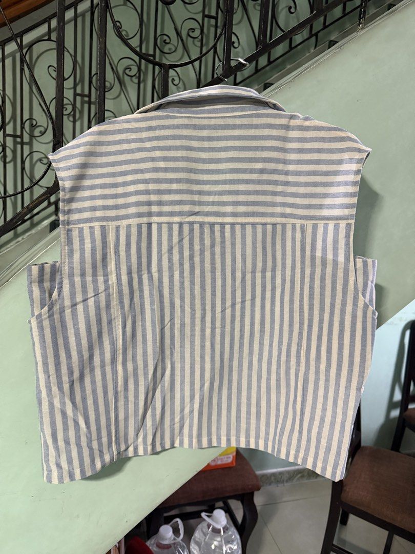 For Me Striped Sleeveless Collared Shirt (Category: Sleeveless) located in Pasig City. Submitted by aprilluxcloset0812 (Listing ID 1461322514, Image 3). Description: - Light blue and white striped sleeveless shirt - Collared neckline with button-up front - Made from a comfortable cotton and polyester blend - Versatile for casual wear or layering - Size: Large RFS: decluttering EVERYTHING MUST GO‼️Just make a reasonable offer ❤️ All items ON HAND,