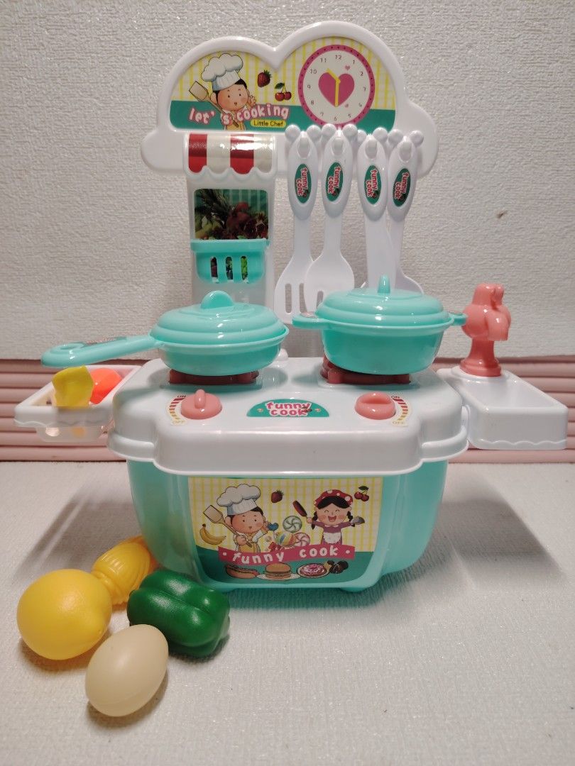 Funny Cook Little Chef Pretend Play Kitchen Set (Category: Kids Toys) located in Marikina City. Submitted by sedyrah (Listing ID 1461146209, Image 1). Description: - Fun pretend play kitchen set for kids. - Includes pots, pans, utensils, and play food (lemon, bell pepper, egg). - Features cute chef graphics and a clock. - Encourages imaginative play and learning about cooking. - Easy to assemble and clean..