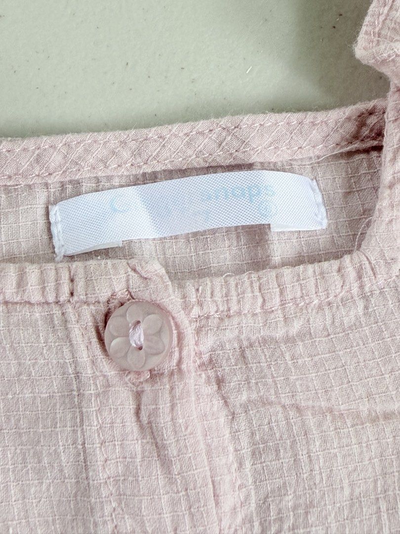 Gingersnaps Pink Ruffle Blouse 6 months (Category: Babies & Kids Fashion) located in Quezon City. Submitted by doryscloset (Listing ID 1461157967, Image 3). Description: - Adorable pink crop top - Features a stylish square neckline - Ruffled sleeves add a feminine touch - Convenient button-up front - Comfortable textured fabric - Versatile for casual or dressy occasions - Easily pairs with jeans or skirts.