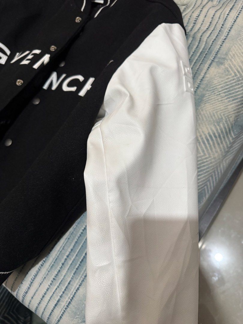 Givenchy Black White Varsity Jacket (Category: Coats, Jackets and Outerwear) located in Makati City. Submitted by erodriguez (Listing ID 1461213298, Image 3). Description: - Classic black and white Givenchy varsity jacket - Iconic Givenchy logo across the chest - White leather sleeves - Ribbed collar, cuffs, and hem - Snap button closure - Versatile for streetwear looks Negotiable.