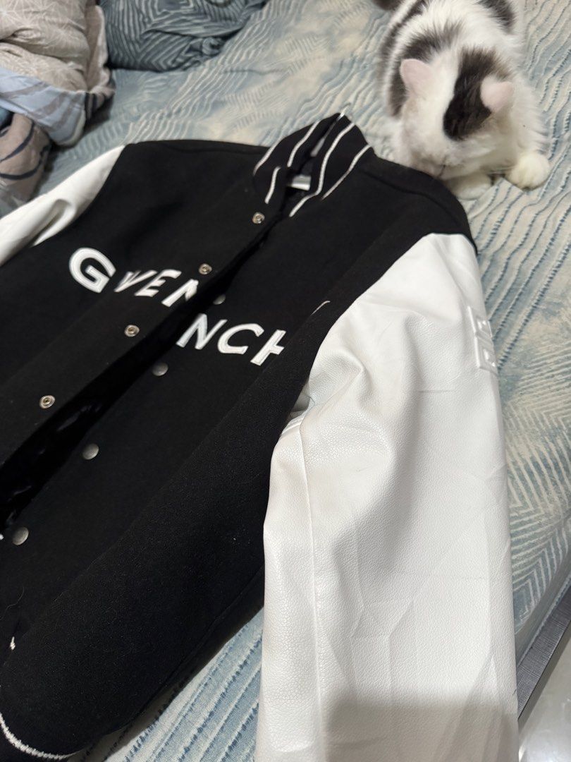 Givenchy Black White Varsity Jacket (Category: Coats, Jackets and Outerwear) located in Makati City. Submitted by erodriguez (Listing ID 1461213298, Image 2). Description: - Classic black and white Givenchy varsity jacket - Iconic Givenchy logo across the chest - White leather sleeves - Ribbed collar, cuffs, and hem - Snap button closure - Versatile for streetwear looks Negotiable.