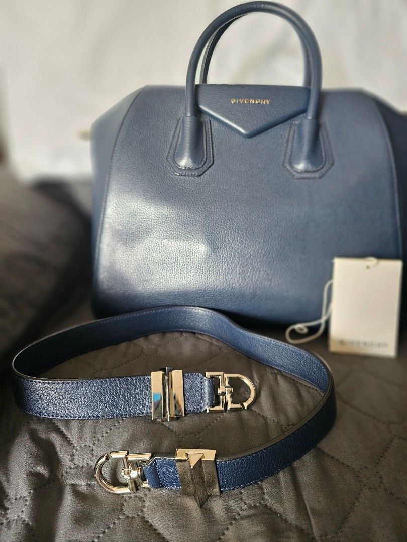 Givenchy Navy Blue Leather Antigona Bag with Strap (Category: Luxury Bags & Wallets) located in Mandaluyong City. Submitted by calibre915 (Listing ID 1461154602, Image 2). Description: - Authentic Givenchy Antigona bag - Color: Navy Blue Leather - Closure: Zip - Features: Embossed Givenchy logo on front - Includes: Original dust bag, authenticity card, detachable navy blue leather strap with silver hardware - Medium.