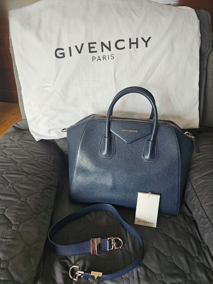 Givenchy Navy Blue Leather Antigona Bag with Strap (Category: Luxury Bags & Wallets) located in Mandaluyong City. Submitted by calibre915 (Listing ID 1461154602, Image 1). Description: - Authentic Givenchy Antigona bag - Color: Navy Blue Leather - Closure: Zip - Features: Embossed Givenchy logo on front - Includes: Original dust bag, authenticity card, detachable navy blue leather strap with silver hardware - Medium.