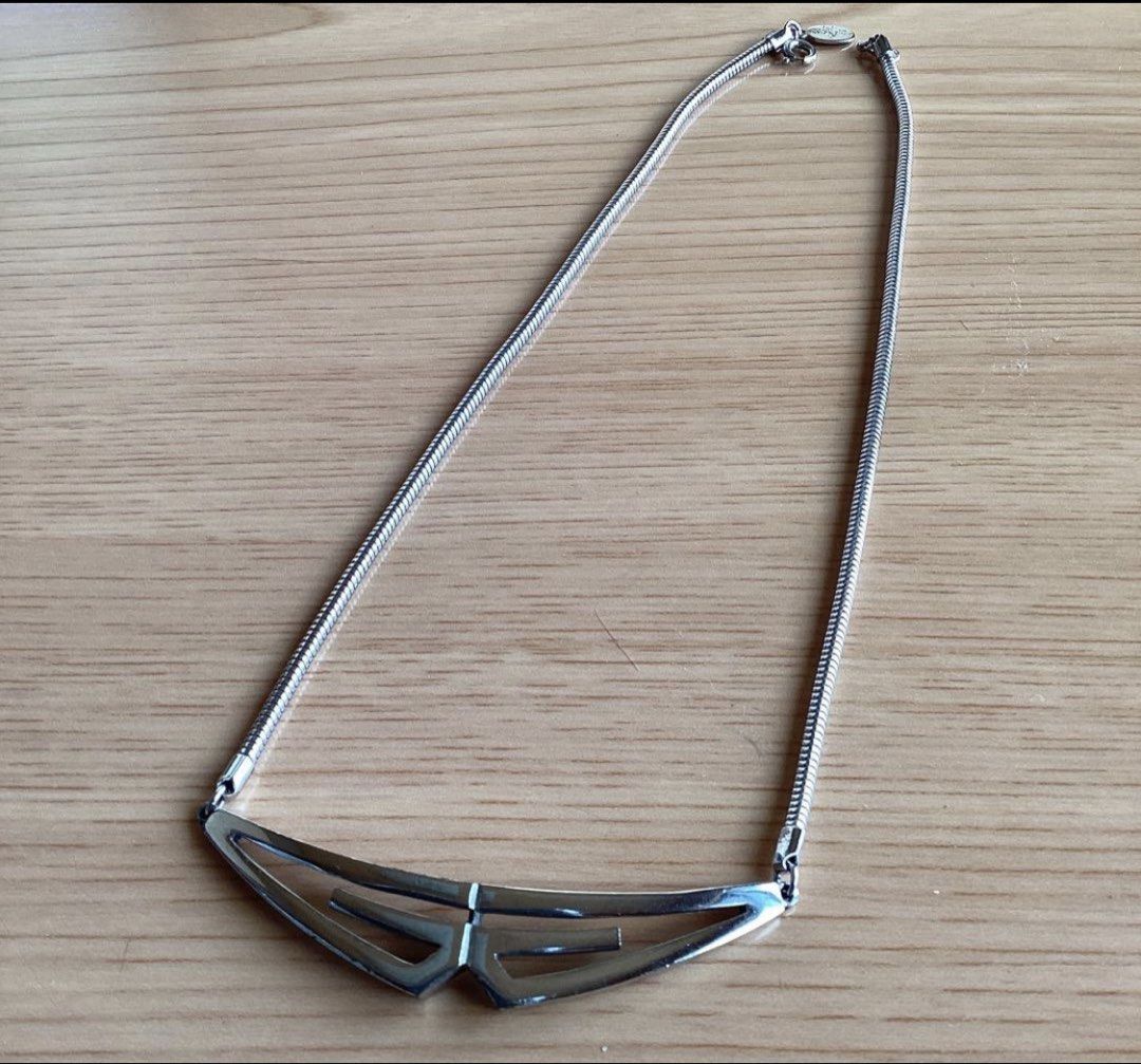 Givenchy Silver tone Geometric necklace (Category: Luxury Accessories) located in Alaminos. Submitted by remyraon_preloved (Listing ID 1461280526, Image 1). Description: - Authentic Givenchy brand - 1976 signature logo plate near clasp - Sleek silver tone necklace - Unique geometric pendant with modern, angular design - Smooth snake chain - Minimalist yet statement-making - Versatile: dress up or down, pairs well with many outfits.