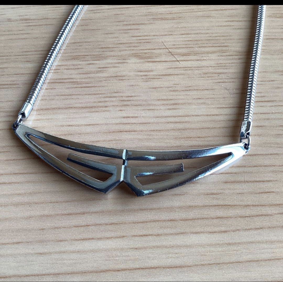 Givenchy Silver tone Geometric necklace (Category: Luxury Accessories) located in Alaminos. Submitted by remyraon_preloved (Listing ID 1461280526, Image 2). Description: - Authentic Givenchy brand - 1976 signature logo plate near clasp - Sleek silver tone necklace - Unique geometric pendant with modern, angular design - Smooth snake chain - Minimalist yet statement-making - Versatile: dress up or down, pairs well with many outfits.