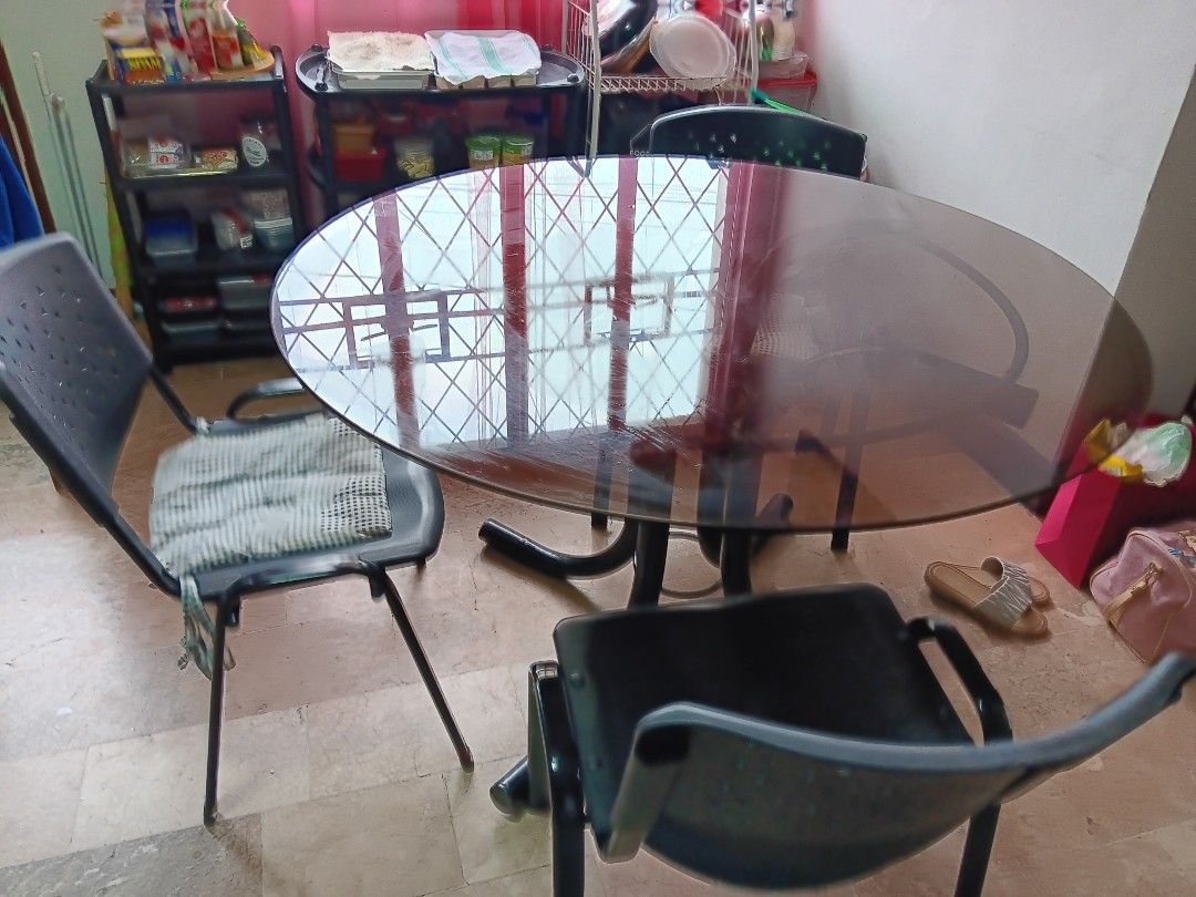 Glass Top Dining Table with 4 Chairs (Category: Tables & Sets) located in Las Pinas. Submitted by jesus1smysavi0r (Listing ID 1461133234, Image 3). Description: - Round glass top dining table - Sturdy black metal base - Includes 4 black plastic chairs - One chair has a grey cushion - Ideal for small dining areas or kitchens - Tabletop is reflective - Chairs are stackable for easy storage - Selling as a complete set.