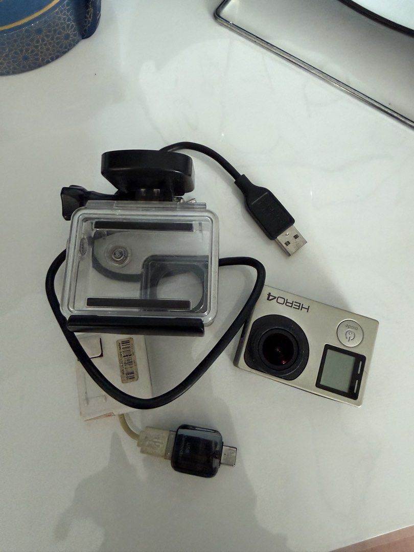 GoPro HERO4 Silver Action Camera with Waterproof Case & Accessories (Category: Cameras) located in Manila. Submitted by kristielyntan (Listing ID 1461129314, Image 1). Description: - GoPro HERO4 Silver camera - Waterproof housing case included - USB charging cable - Small adapter - Ideal for capturing adventures - Ready for your next trip.