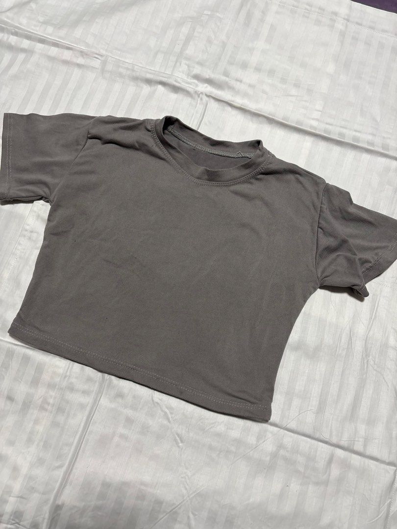 Grey Cropped T-Shirt (Category: Shirts) located in Pasay City. Submitted by nicoletlntn_ (Listing ID 1461230617, Image 1). Description: - Basic grey cropped t-shirt - Short sleeves - Round neckline - Versatile for layering or wearing on its own - Effortlessly pairs with various bottoms.