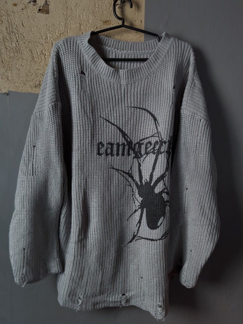 Grey Distressed Spider Graphic Knit Sweater (Category: Longsleeves) located in Manila. Submitted by andreiming84756 (Listing ID 1461189698, Image 1). Description: - Oversized grey knit sweater - Distressed/ripped look on sleeves and hem - Black spider graphic with text on front - Super comfy and cozy - Edgy, cool vibe - Ideal for layering.