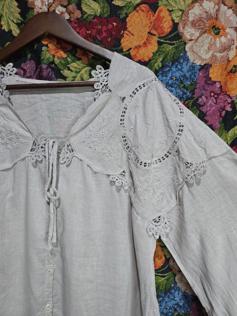 Grey Lace Collar Button Up Blouse (Category: Blouses) located in Paranaque City. Submitted by titaartestudio (Listing ID 1461189498, Image 2). Description: - Grey button-up blouse - Pretty lace collar with embroidery details - Long sleeves with gathered cuffs - Lightweight fabric - Versatile for dressing up or down.
