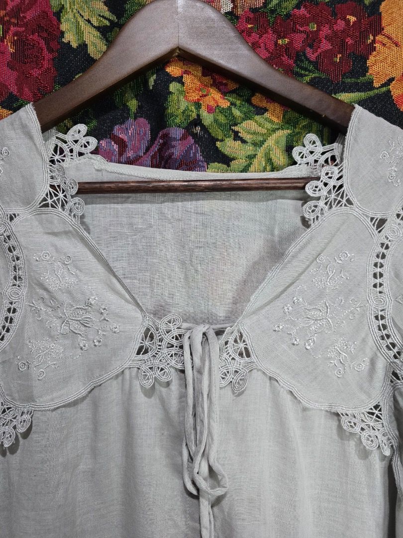 Grey Lace Collar Button Up Blouse (Category: Blouses) located in Paranaque City. Submitted by titaartestudio (Listing ID 1461189498, Image 3). Description: - Grey button-up blouse - Pretty lace collar with embroidery details - Long sleeves with gathered cuffs - Lightweight fabric - Versatile for dressing up or down.