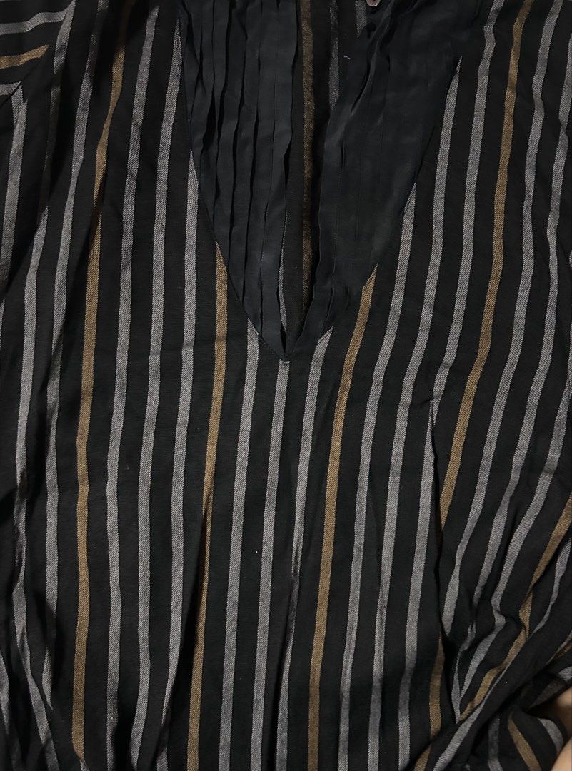 GUCCI (Category: Shirts) located in Davao. Submitted by sart0ria85 (Listing ID 1461310792, Image 3). Description: Vintage Guccio Gucci blouse dated in 1976. In Black with thin vertical grey and gold stripes. High ruffled neckline with button closure, long sleeves with buttoned cuffs. An excellent 50 year old, well preserved blouse. - Material: 100% SILK on breast V pleats. Body is made of 100%WOOL. MADE IN ITALY 🇮🇹 40/LARGE. Size 8 EXCELLENT CO