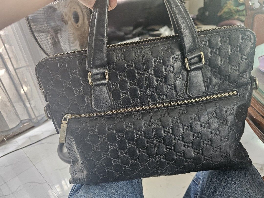 Gucci Black Monogram Leather Briefcase Bag (Category: Luxury Bags & Wallets) located in Tagbilaran City. Submitted by lugarpogi (Listing ID 1461123958, Image 2). Description: - Authentic Black Gucci Monogram Leather Briefcase - Secure zip closure - Two comfortable top handles - Includes a detachable shoulder strap for versatile carrying - Organized interior with zip pockets and compartments - Shows some signs of wear on leather and hardware, cons