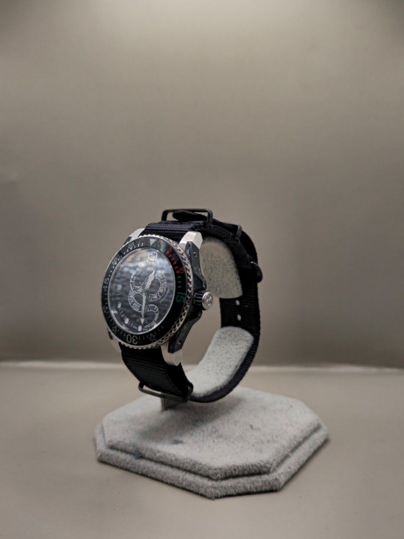 GUCCI Dive Watch Black Nylon Strap (Category: Luxury Watches) located in Manila. Submitted by secretwatch.mnl (Listing ID 1461311074, Image 3). Description: - Authentic Gucci Dive watch - Durable black nylon strap - Rotating bezel with signature green and red markers - Convenient date window on the dial - Water resistant for peace of mind - Ideal for both everyday wear and diving activities.