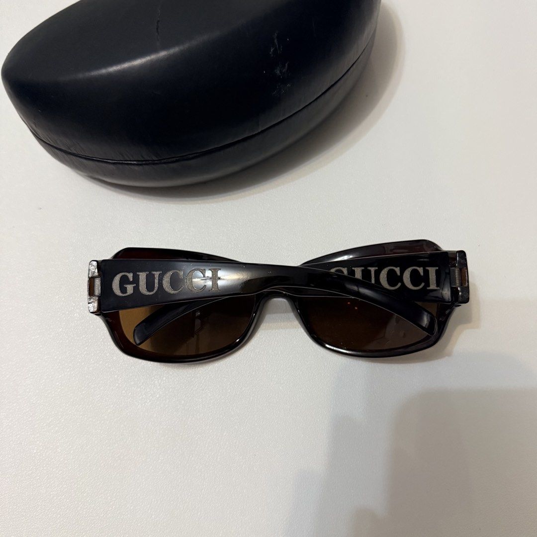 Gucci Sunglasses (Category: Sunglasses & Eyewear) located in Angeles City. Submitted by a.k.onlineshopp (Listing ID 1461227096, Image 1). Description: * Authentic Gucci sunglasses * Dark brown frames * Large Gucci logo on the arms * Comes with a non-original hard case * Perfect for sunny days.