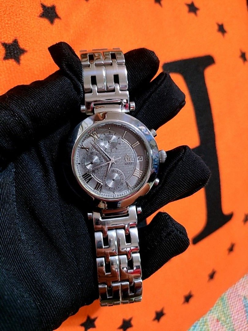 Guess Collection Chronograph Watch Silver Tone (Category: Women's Watches) located in Baliuag. Submitted by marieannfernando23 (Listing ID 1461284195, Image 2). Description: - Silver-tone GC watch - Chronograph function with 3 sub-dials - Roman numeral hour markers - Gray Dial - Big face - Stainless steel band - Sophisticated and versatile style - Like new .