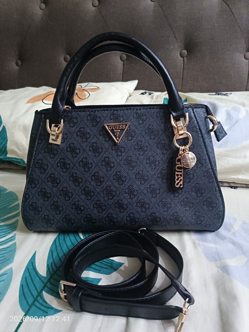 Guess Monogram Satchel Handbag with Strap (Category: Luxury Bags & Wallets) located in Navotas City. Submitted by ladyjansen (Listing ID 1461182992, Image 1). Description: - Classic Guess satchel bag - All-over monogram print - Detachable shoulder strap included - Elegant gold-tone hardware - Signature Guess logo charm - Multiple interior compartments for organization - Ideal everyday bag.