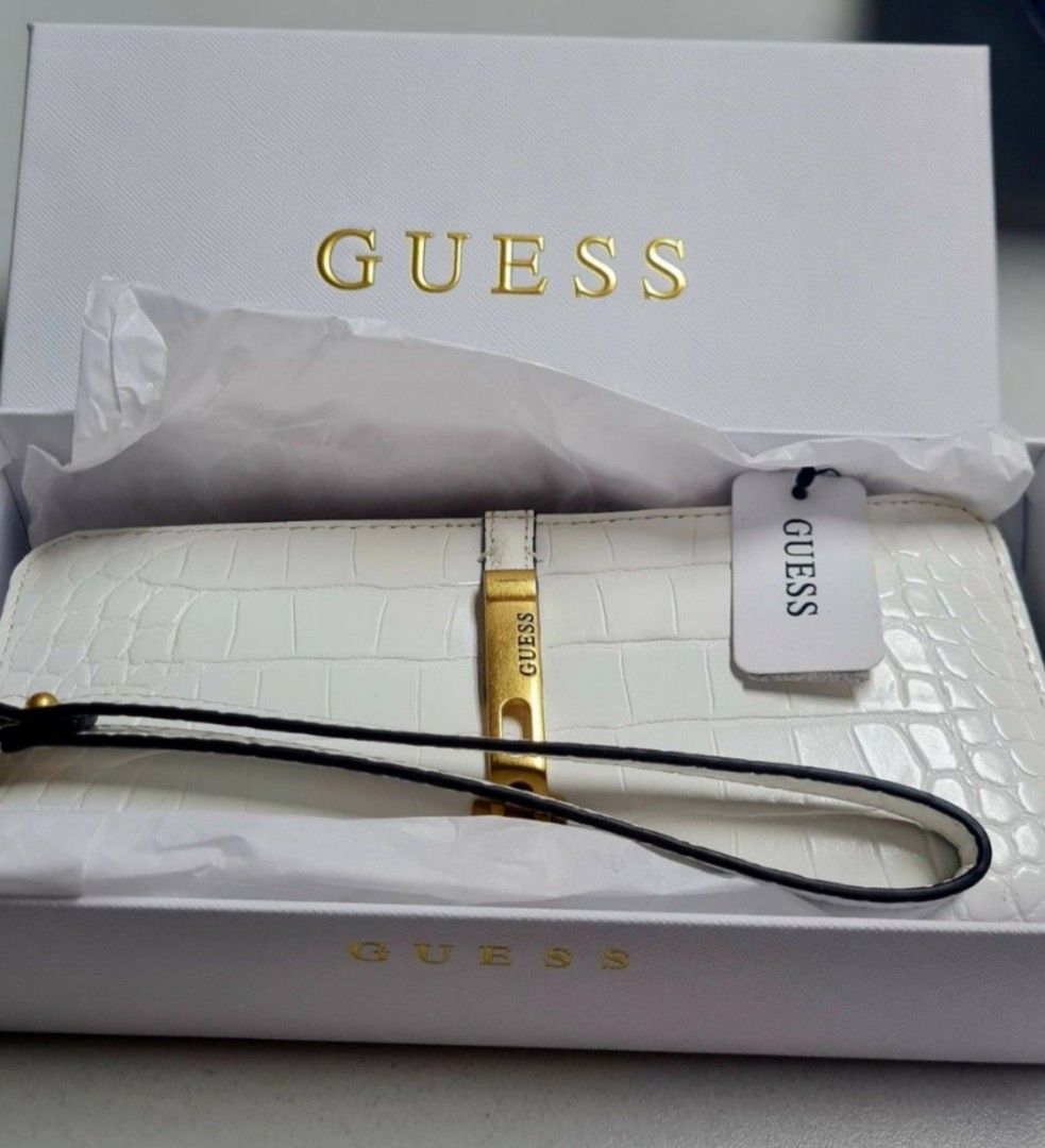 GUESS White Croc Embossed Wristlet Wallet (Category: Wallets & Card holders) located in Manila. Submitted by jazgotlucky (Listing ID 1461255306, Image 1). Description: - GUESS white croc embossed wristlet wallet - Comes with original box and tags - Multiple card slots and compartments for organization - Elegant gold hardware detail on the front - Detachable wrist strap for convenience - never been used, decluttering.