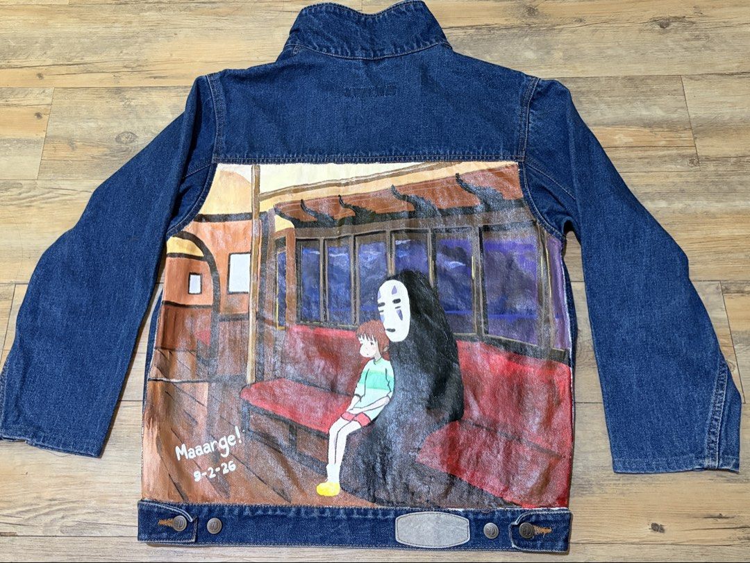 Hand-Painted Studio Ghibli Spirited Away Denim Jacket (Category: Coats, Jackets and Outerwear) located in Manila. Submitted by popofcolor.ph (Listing ID 1461299151, Image 3). Description: - Custom hand-painted denim jacket - Features Spirited Away scene with Chihiro and No-Face on the train - Unique, one-of-a-kind anime fan item - Vibrant and detailed artwork - Perfect for personal style and collectors.
