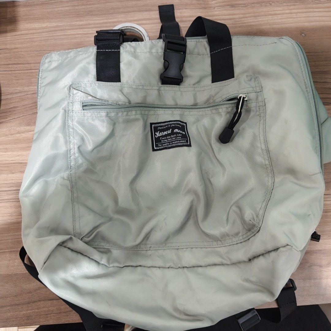 Harvest Moon Tote Bag (Category: Tote Bags) located in Manila. Submitted by narju1234 (Listing ID 1461125107, Image 1). Description: - Light grey tote bag from Harvest Moon - Front zip pocket for easy access - Main compartment with secure drawstring closure - Versatile: can be carried as a tote or worn as a backpack - Adjustable straps for comfortable wear - Ideal for everyday errands or travel adventures.