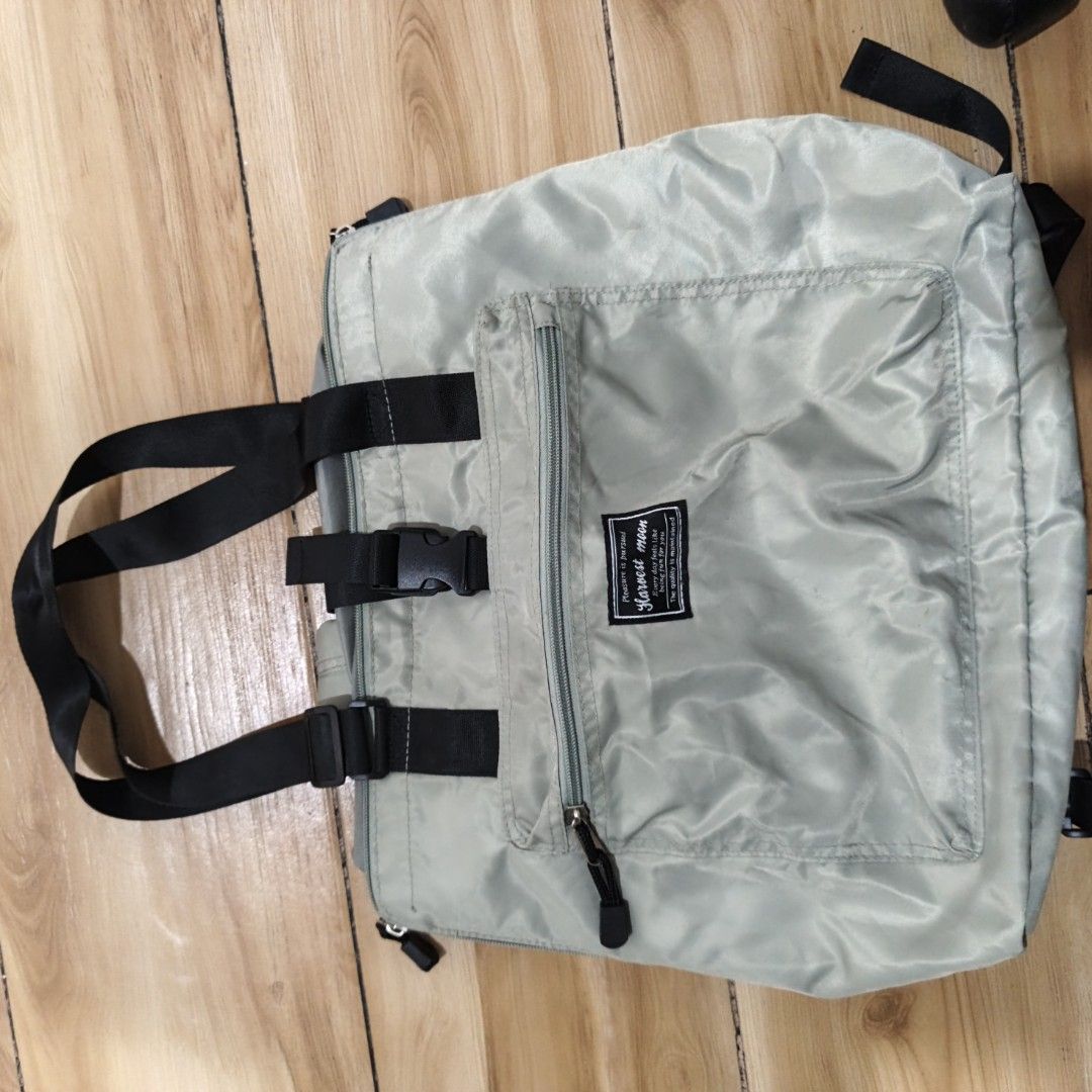 Harvest Moon Tote Bag (Category: Tote Bags) located in Manila. Submitted by narju1234 (Listing ID 1461125107, Image 3). Description: - Light grey tote bag from Harvest Moon - Front zip pocket for easy access - Main compartment with secure drawstring closure - Versatile: can be carried as a tote or worn as a backpack - Adjustable straps for comfortable wear - Ideal for everyday errands or travel adventures.