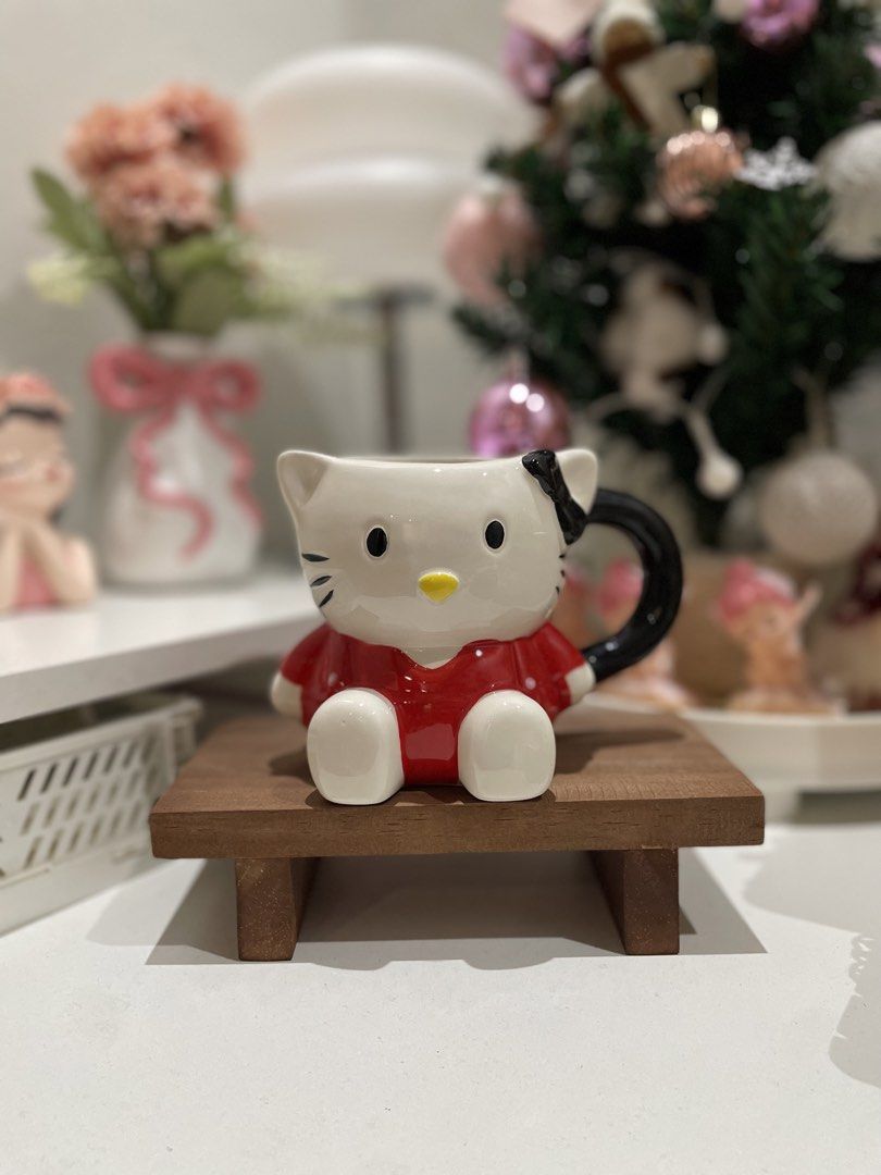Hello Kitty Mug Red Dress (Category: Coffee & Tea Tableware) located in Quezon City. Submitted by mugs.meowph (Listing ID 1461289554, Image 1). Description: - Adorable Kitty mug - Features Kitty in a red dress with white polka dots - Black handle - Includes a small wooden stand - Perfect for your morning coffee or tea - A must-have for any Kitty enthusiast!.