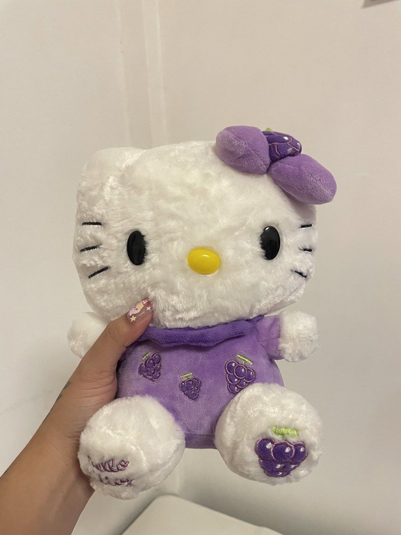 Hello Kitty Plush Toy Purple Grapes Design (Category: Plushies & Soft Toys) located in Iba. Submitted by wealtheallymari99 (Listing ID 1461115795, Image 1). Description: - Adorable Kitty plush toy. - Features a charming purple dress adorned with grape designs. - Matching grape detail on the bow. - " Kitty" elegantly embroidered on one foot. - Exceptionally soft and fluffy texture. - Ideal for Kitty collectors and fans alike..