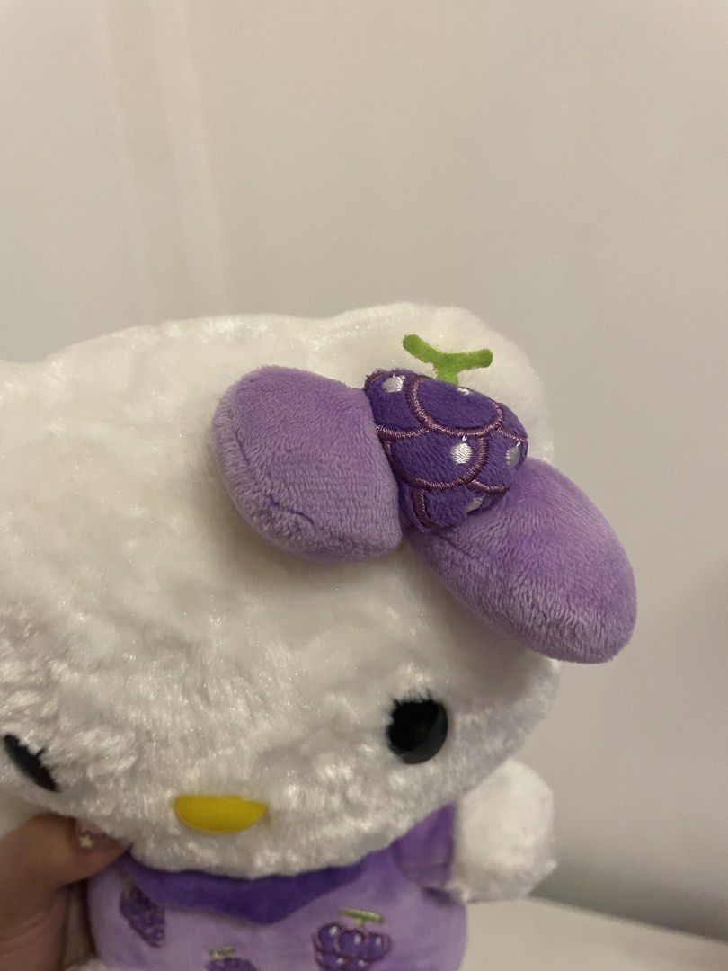 Hello Kitty Plush Toy Purple Grapes Design (Category: Plushies & Soft Toys) located in Iba. Submitted by wealtheallymari99 (Listing ID 1461115795, Image 2). Description: - Adorable Kitty plush toy. - Features a charming purple dress adorned with grape designs. - Matching grape detail on the bow. - " Kitty" elegantly embroidered on one foot. - Exceptionally soft and fluffy texture. - Ideal for Kitty collectors and fans alike..