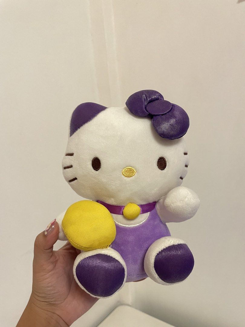 Hello Kitty Plush Toy Purple Outfit (Category: Plushies & Soft Toys) located in Iba. Submitted by wealtheallymari99 (Listing ID 1461115770, Image 1). Description: - Adorable Kitty plush toy - Stands approximately 8 inches tall - Features a cute purple outfit with a yellow accessory - Super soft and cuddly, perfect for hugs! - Ideal for Kitty collectors or as a thoughtful gift - Authentic Sanrio merchandise.