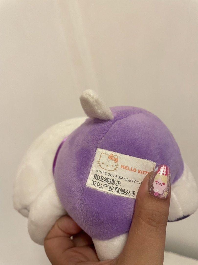 Hello Kitty Plush Toy Purple Outfit (Category: Plushies & Soft Toys) located in Iba. Submitted by wealtheallymari99 (Listing ID 1461115770, Image 3). Description: - Adorable Kitty plush toy - Stands approximately 8 inches tall - Features a cute purple outfit with a yellow accessory - Super soft and cuddly, perfect for hugs! - Ideal for Kitty collectors or as a thoughtful gift - Authentic Sanrio merchandise.