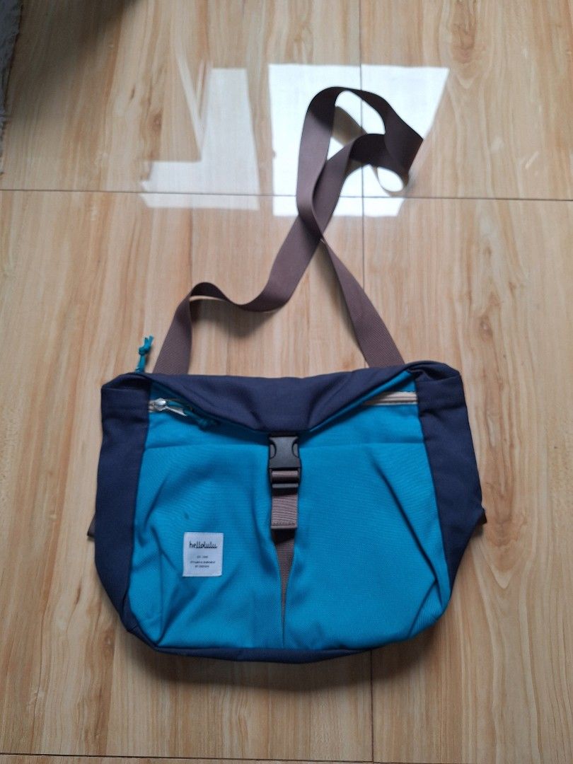 hellolulu Messenger Bag Blue (Category: Cross-body Bags) located in Rizal. Submitted by jokicmvp3 (Listing ID 1461135784, Image 1). Description: - Brand: hellolulu - Color: Blue and Navy - Main compartment with vibrant purple lining - Convenient front zip pocket - Adjustable strap with secure buckle closure - Ideal for everyday carry or travel adventures used only a few times. buyer pays for shipping from my location in Taytay side of Greenwoods 
