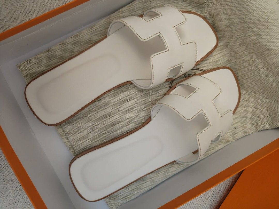 Hermès Blanc Oran Sandal (Category: Flats & Sandals) located in Quezon City. Submitted by mmmm2000 (Listing ID 1461311510, Image 2). Description: These are a pair of white leather Hermès Oran sandals featuring the iconic cut-out "H" strap design..