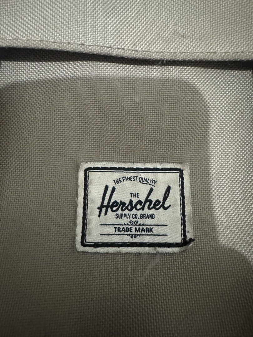 Herschel Supply Co. Backpack Grey Tan Straps (Category: Backpacks) located in Manila. Submitted by oddcrystal_0a3d5b (Listing ID 1461294543, Image 2). Description: - Classic Herschel backpack in grey canvas - Tan faux leather straps with buckle closures - Padded mesh back and shoulder straps for ultimate comfort - Convenient front pocket with buckle closure - Subtle pink stripe detail on top flap - Ideal for school, work, or everyday carry.