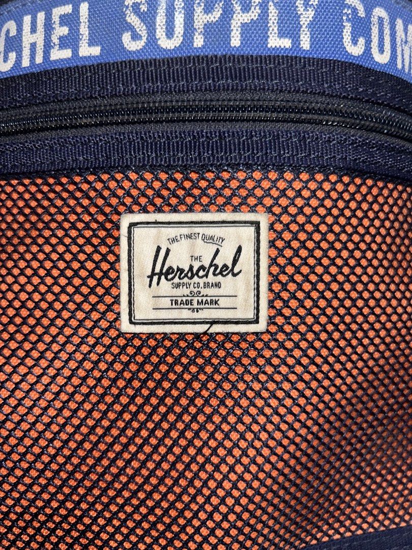Herschel Supply Co. Crossbody Bag (Category: Cross-body Bags) located in Barotac Nuevo. Submitted by ehsherjohn27 (Listing ID 1461144485, Image 2). Description: - Herschel Supply Co. crossbody bag - Color: Navy blue with orange mesh front panel - "Herschel Supply Company" text detail - Interior "Welcome to Herschel" tag - Adjustable strap for comfortable wear - Secure zipped main compartment.