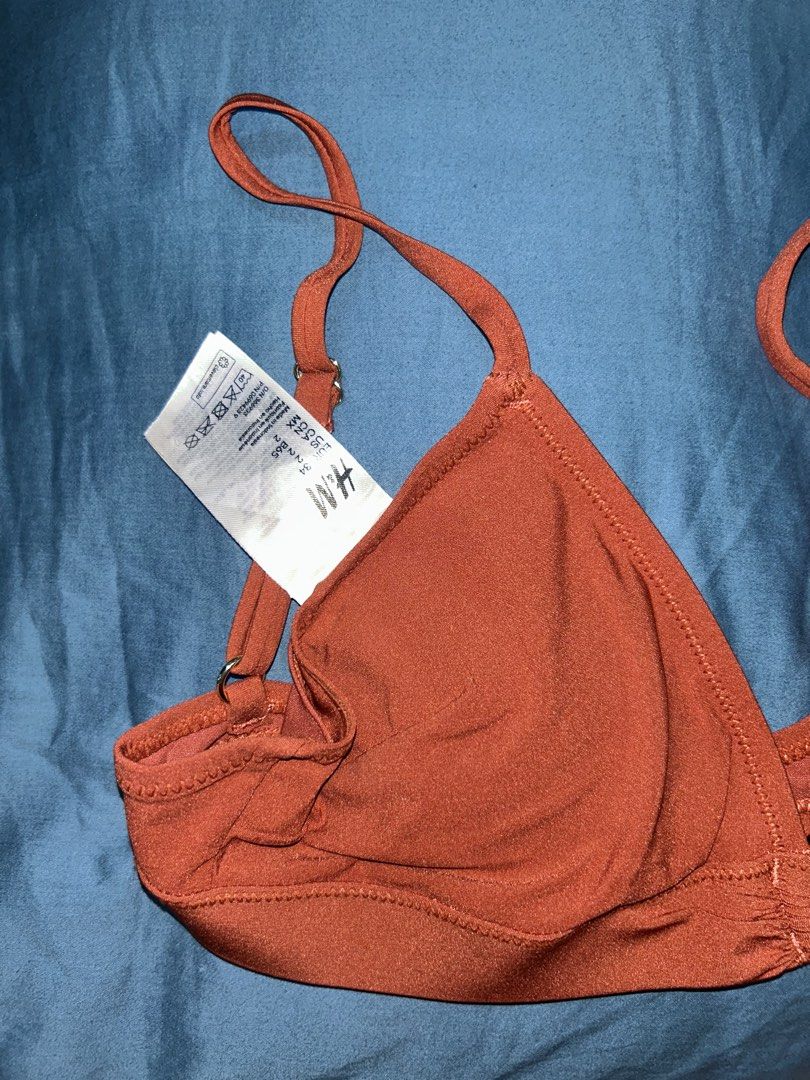 H&M Rust Orange Ring Detail Triangle Bikini Top (Category: Bikinis & Swimsuits) located in Palo. Submitted by kaleidoscope_676 (Listing ID 1461123547, Image 3). Description: - Brand: H&M - Color: Rust Orange - Features: Center ring detail, adjustable straps, clasp back closure - Condition: Brand new with tags attached - Ideal for: Beach trips, pool days.