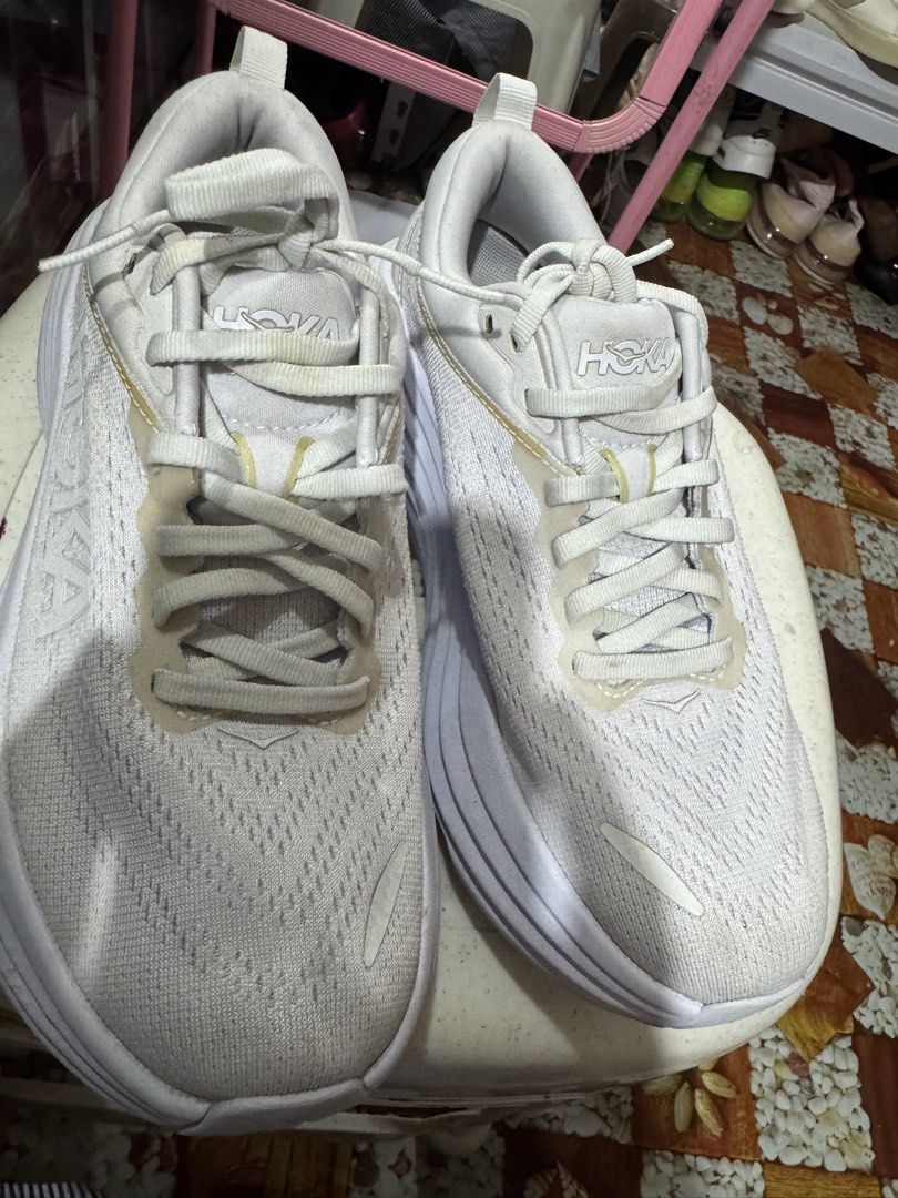 Hoka One (Category: Sneakers & Footwear) located in Manila. Submitted by wildbear.e10374 (Listing ID 1461196174, Image 2). Description: - White Hoka running shoes - Versatile: suitable for running or everyday wear - Comfortable fit - Soles show minor dirt from use - White laces - Hoka logo featured on the side and sole.